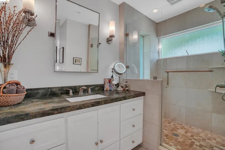 Bathroom with vanity and a shower stall