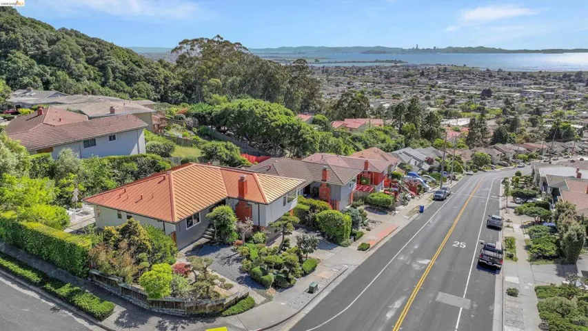 Aerial perspective of suburban area featuring a nearby body of water