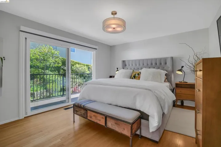 Bedroom featuring access to outside and wood finished floors