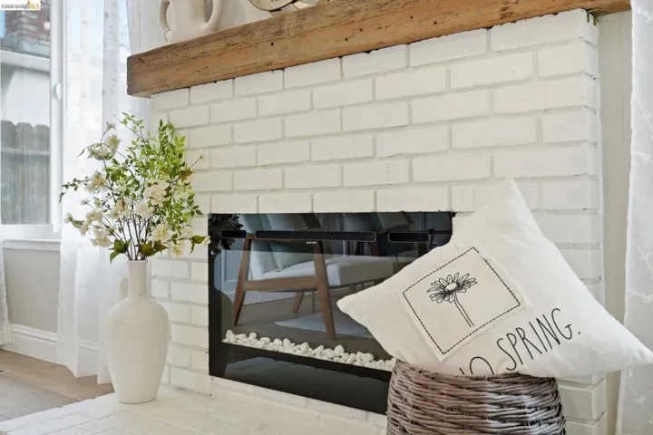 Detailed view of a brick fireplace and wood finished floors