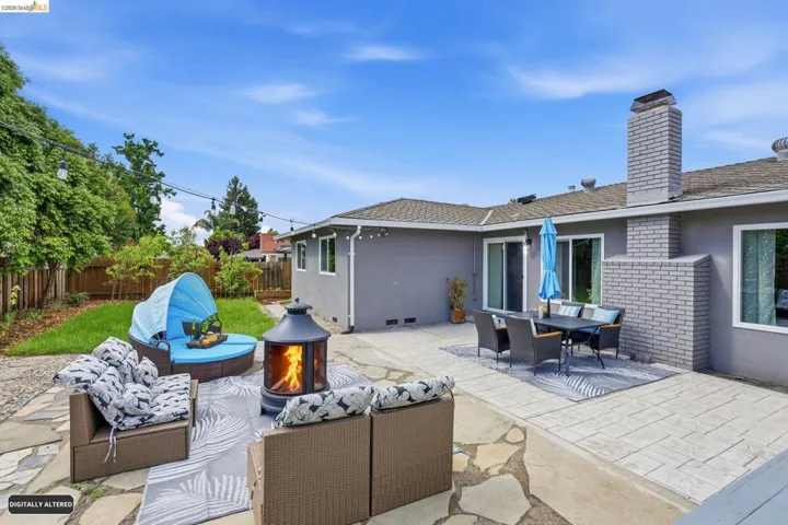 Fenced backyard featuring a patio area, outdoor lounge area, and an outdoor fire pit