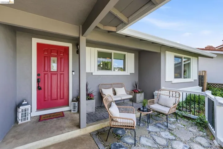 View of exterior entry featuring stucco siding and covered porch