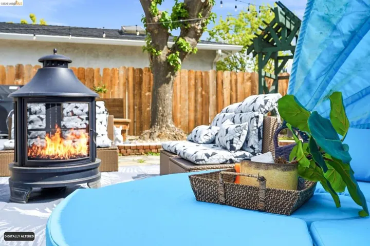 View of patio / terrace featuring a multi sided fireplace and a gazebo