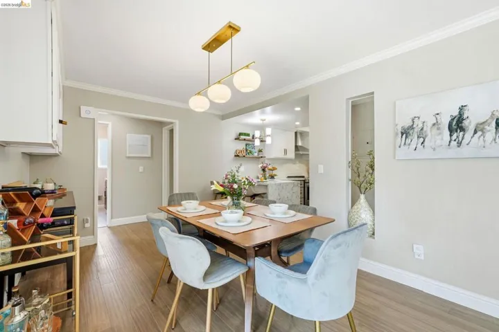 Dining space featuring crown molding and wood finished floors