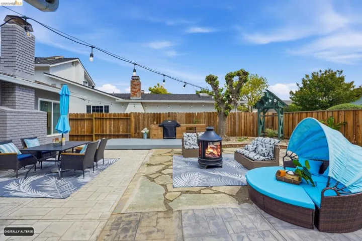 Fenced backyard featuring a patio area, area for grilling, a fire pit, and outdoor dining area