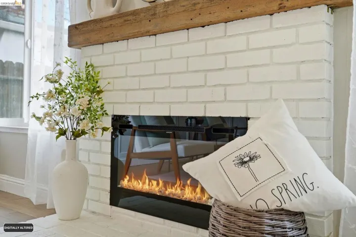 Detailed view of a brick fireplace and wood finished floors