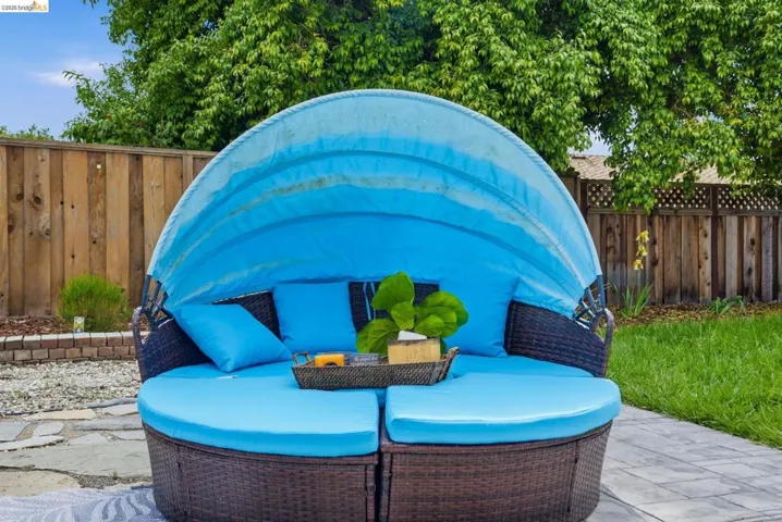 Fenced backyard featuring an outdoor living space and a patio area