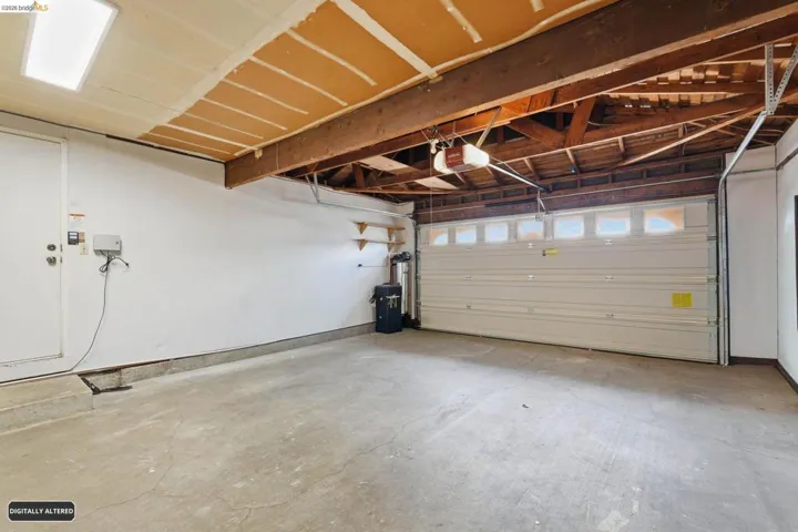 Garage featuring a garage door opener