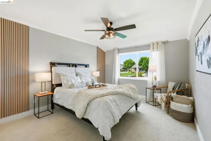 Bedroom featuring crown molding, a ceiling fan, and light carpet