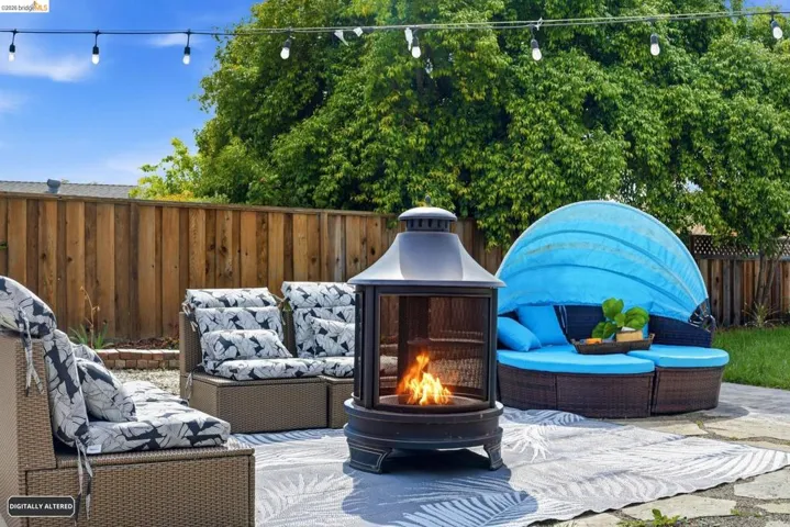 Fenced backyard featuring an outdoor living space and a patio
