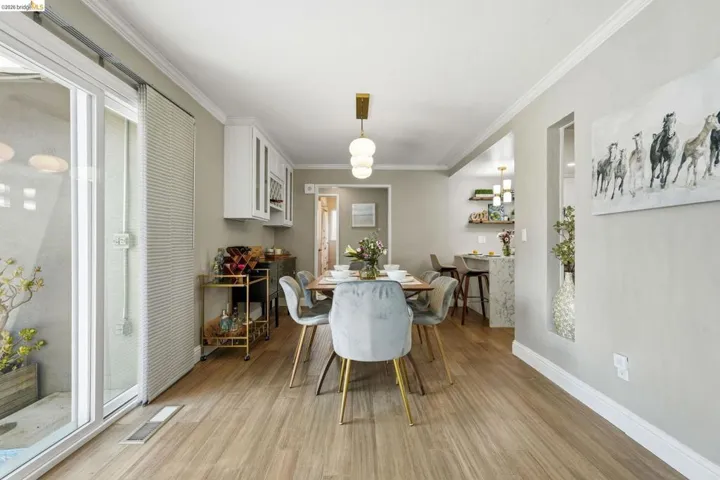 Dining room featuring ornamental molding and light wood-style flooring