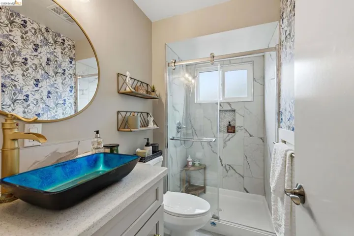 Full bathroom with vanity and a marble finish shower