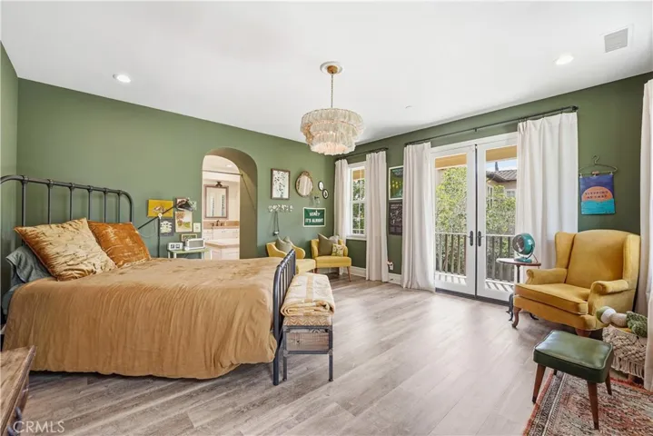 Primary Suite with Balcony overlooking backyard pool