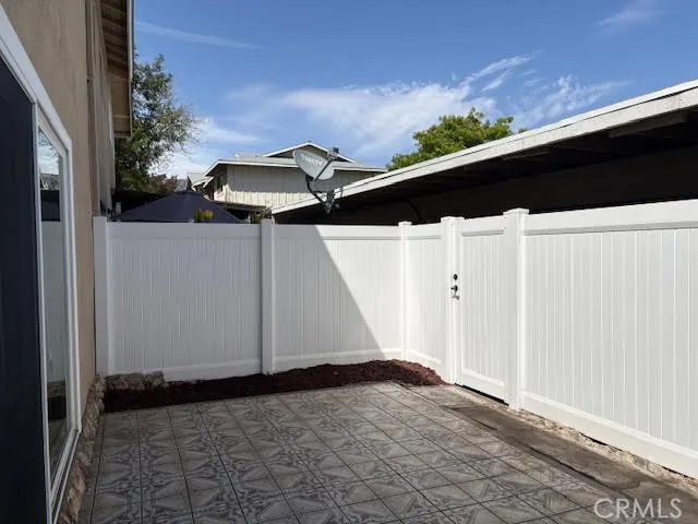 Back Patio with New Vinyl Fencing and direct access to Carport.