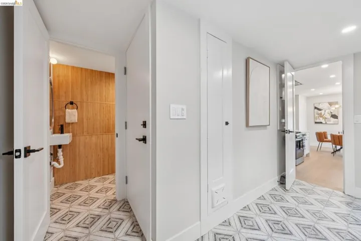 Hall featuring light floors and recessed lighting