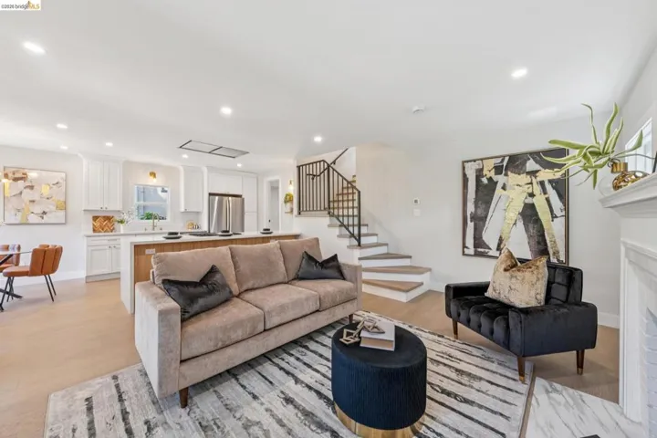 Living area with recessed lighting, light wood finished floors, and a fireplace