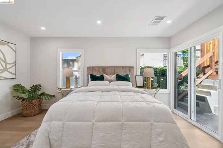 Bedroom with recessed lighting, light wood-type flooring, and access to exterior