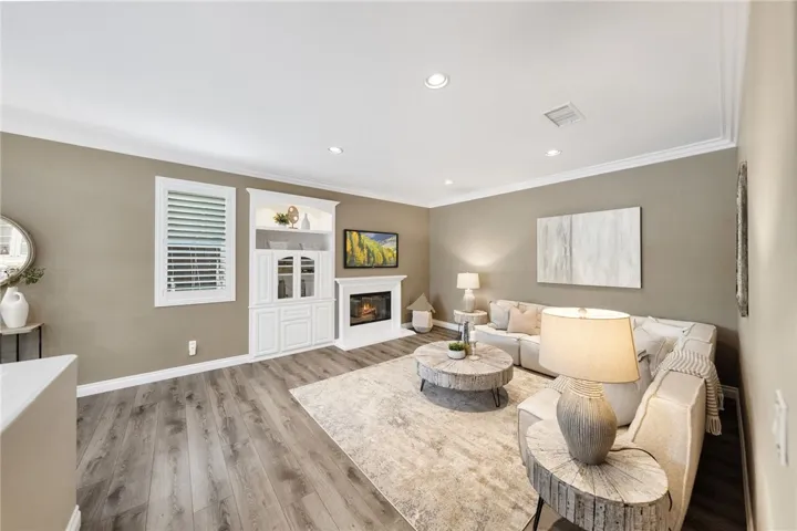 Another view of family room with built-in and fireplace