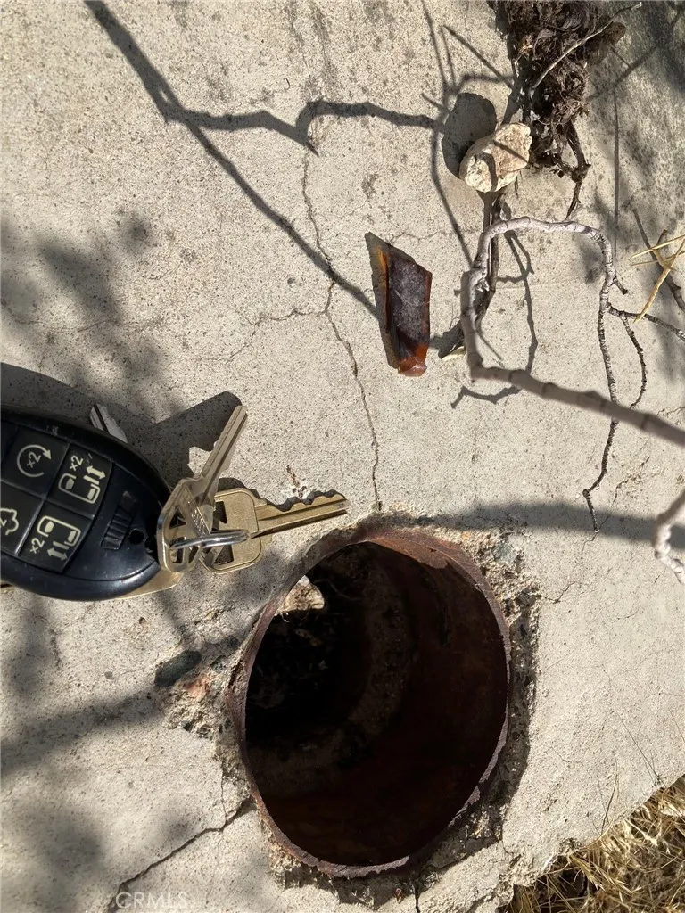 Close up of slab showing pipe embedded in slab.  Keys next to the pipe so you can  estimate size of pipe