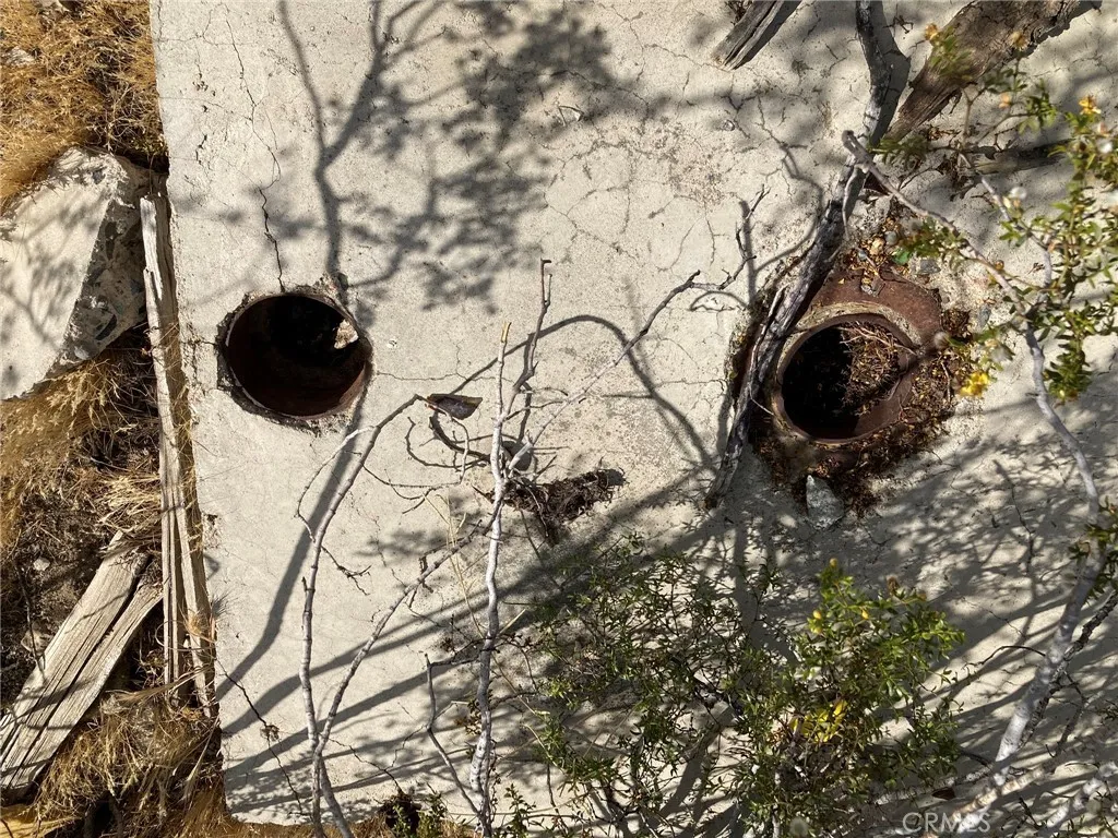 Two pipes in the cement slab.  Maybe there is an old well there?