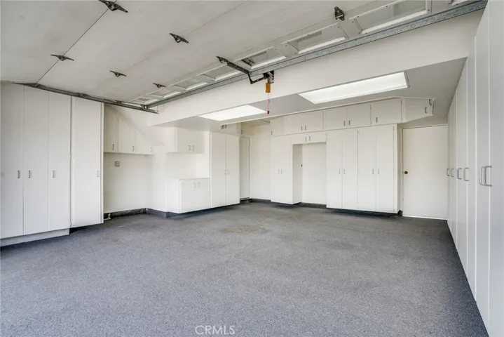 Fully finished garage w/lots of storage cabinets!