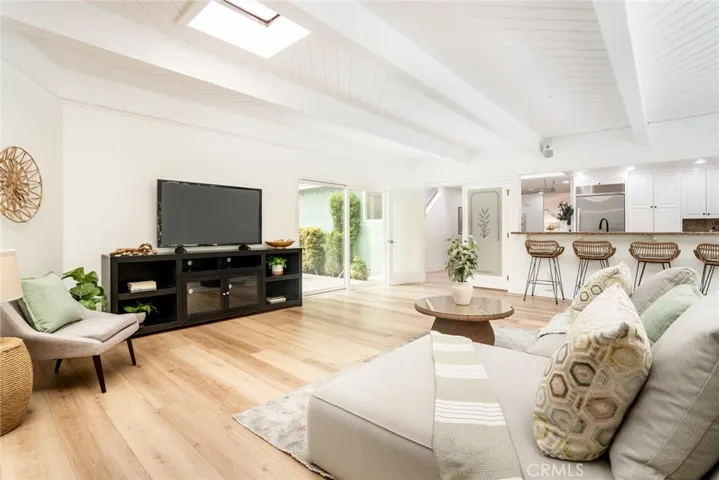 560 sqft family room w/2 slding doors + 2 skylights + tongue in groove beamed ceiling w/fireplace!
