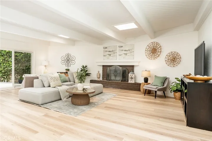 560 sqft family room w/2 slding doors + 2 skylights + tongue in groove beamed ceiling w/fireplace!