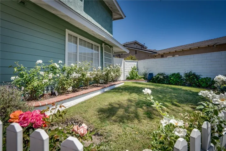 Front yard w/white picket fence & flowers!