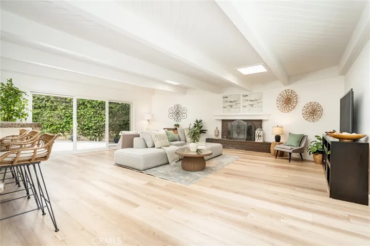 560 sqft family room w/2 slding doors + 2 skylights + tongue in groove beamed ceiling w/fireplace!