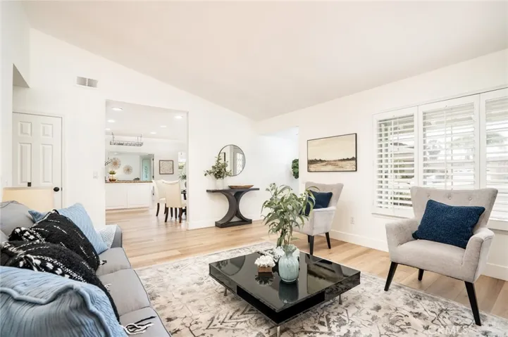 The formal living room has vaulted ceilings & fireplace!