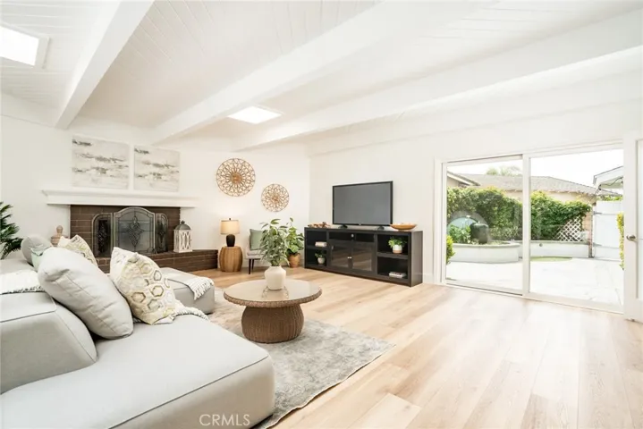 560 sqft family room w/2 slding doors + 2 skylights + tongue in groove beamed ceiling w/fireplace!