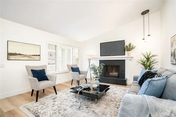 The formal living room has vaulted ceilings & fireplace!