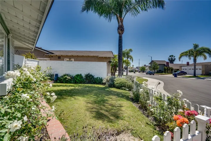 Front yard w/white picket fence & flowers!
