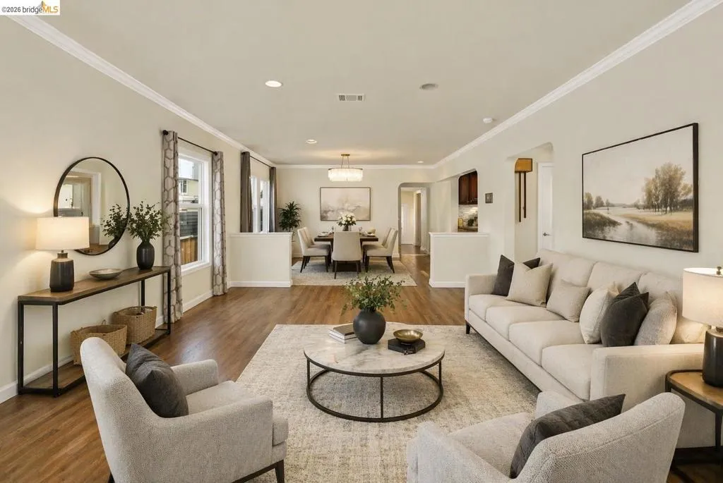 Living area with dark wood-style flooring, crown molding, and recessed lighting