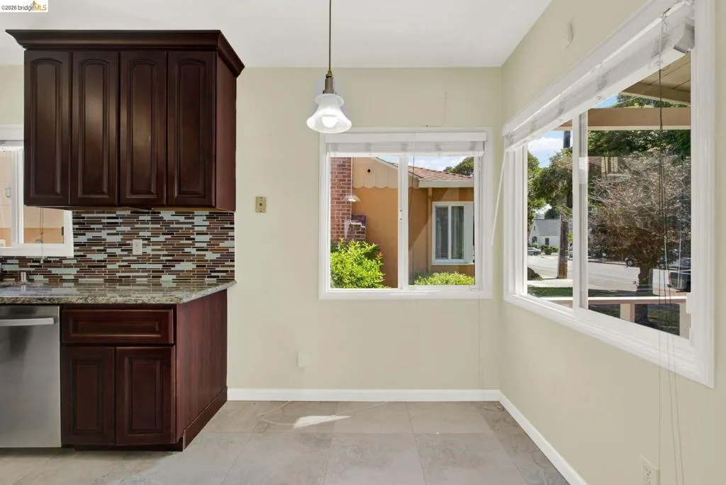 Unfurnished dining area with baseboards and light tile patterned flooring