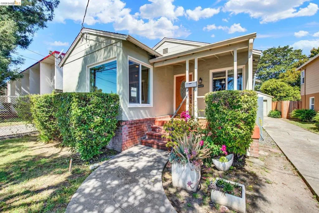 View of front of house featuring covered porch and stucco siding