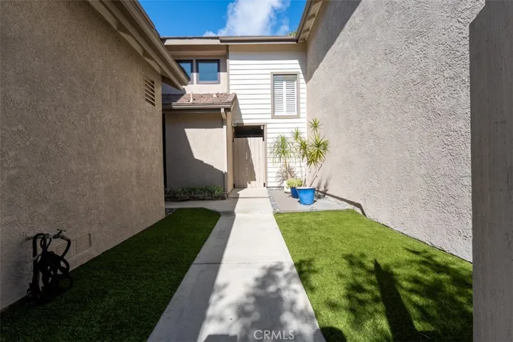 Front yard with security gate and new synthetic turf