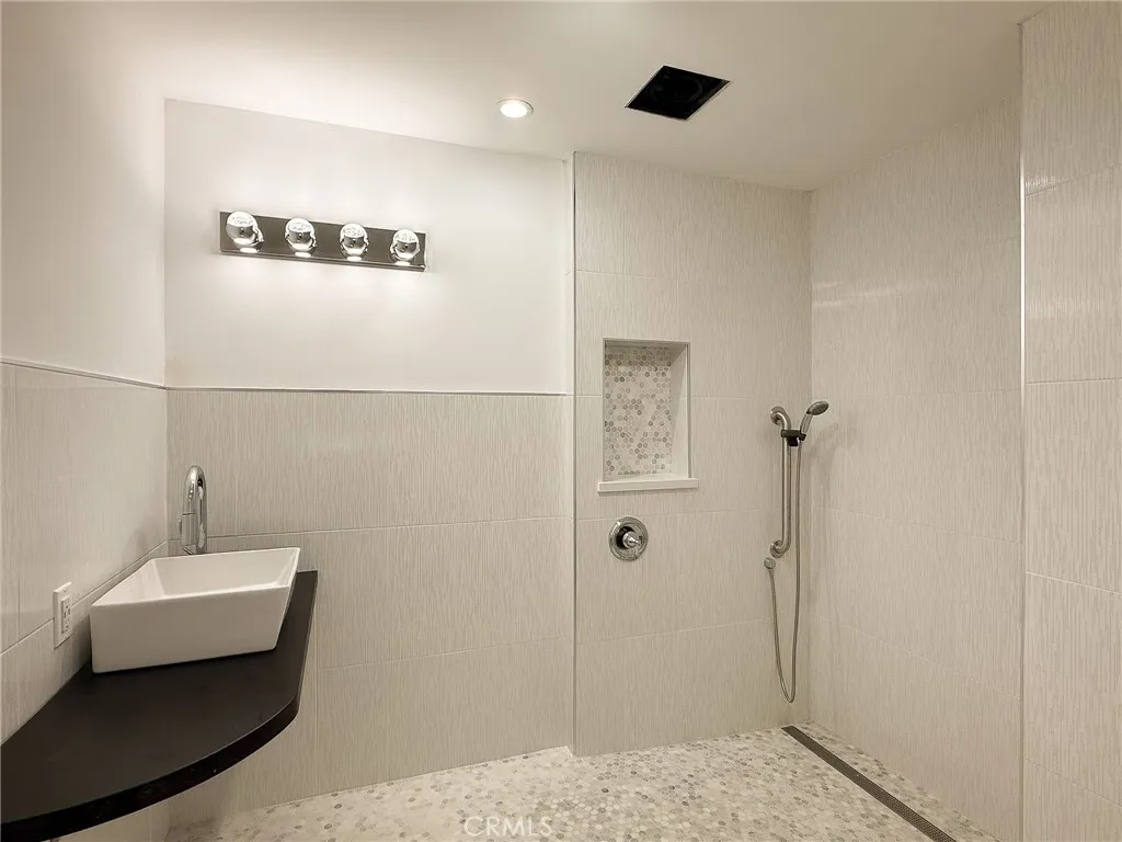 Beautiful Roll-in tiled, remodeled bathroom with shower.