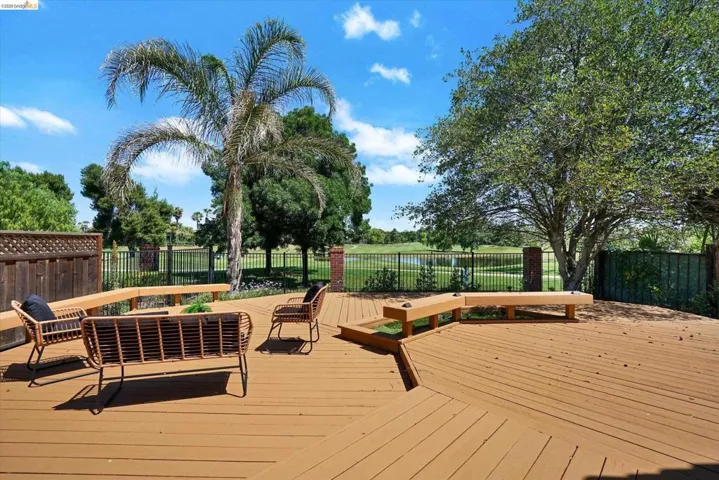 Spacious outdoor deck featuring wood-finish flooring and integrated bench seating