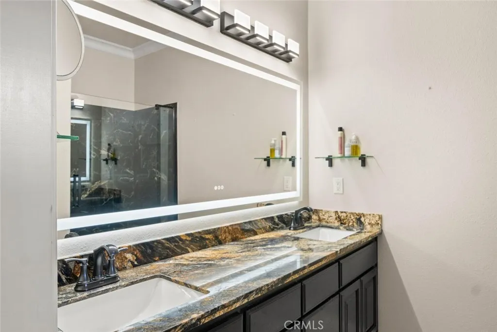 Updated granite counter with double sink and defrosting mirror