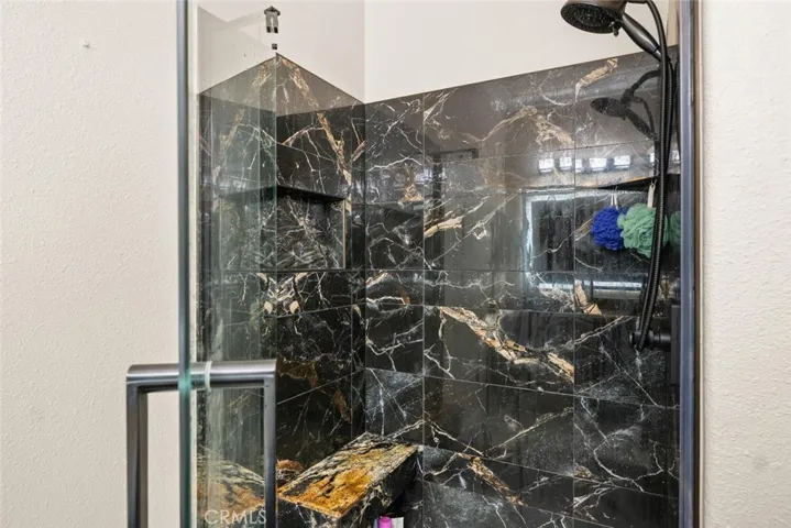 Updated walk in tile shower with tile flooring