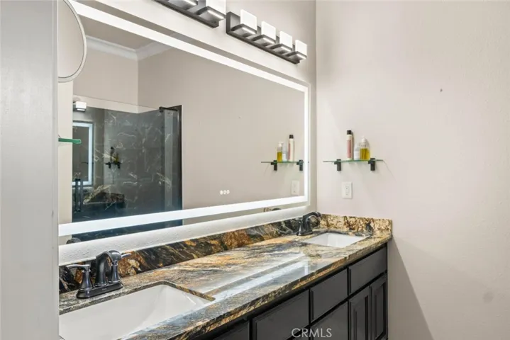 Updated granite counter with double sink and defrosting mirror