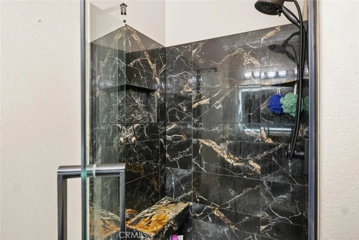 Updated walk in tile shower with tile flooring