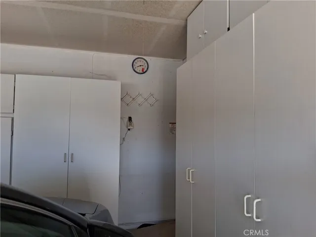 storage cabinet along the side wall of garage.