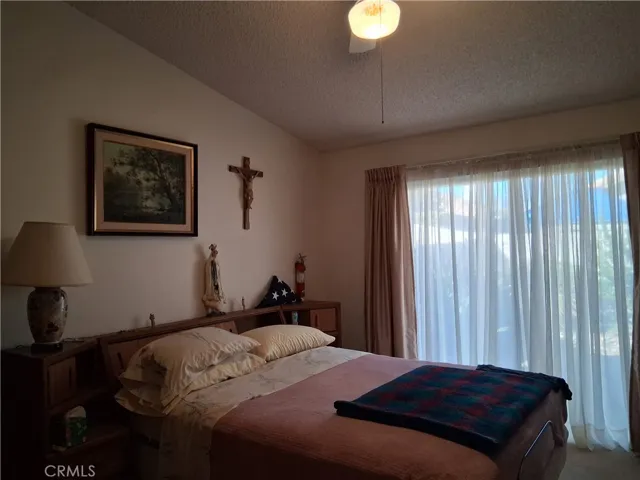 master bedroom with slide door to back yard