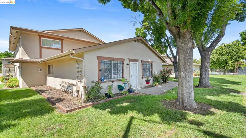 View of front of property featuring stucco siding and stairs