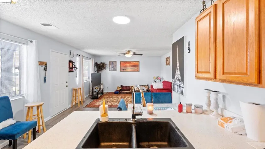 Kitchen featuring a textured ceiling, wood finished floors, and a ceiling fan