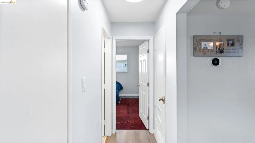 Hallway featuring light wood-style floors