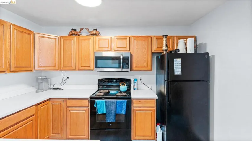 Kitchen with black appliances and light countertops