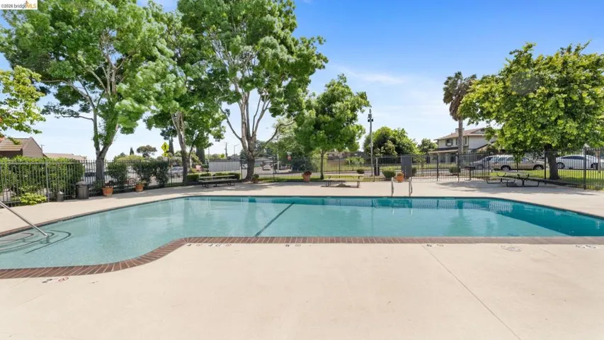 Community pool with a patio area